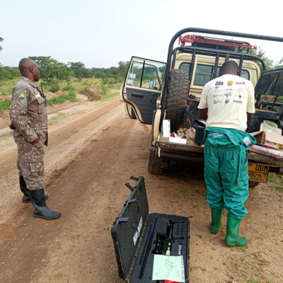 Dr Eric getting his medical kit ready as a ranger watches on_QENP_July_2024